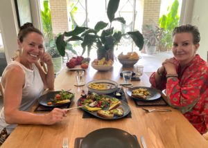 Two smiling women enjoying breakfast