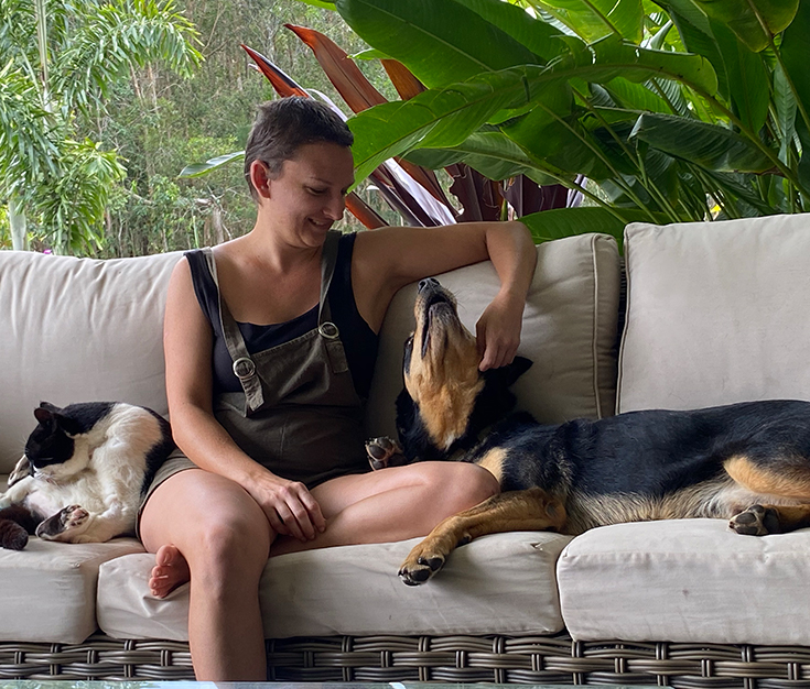 Quiet time with friends Woman with friendly dog and cat on couch